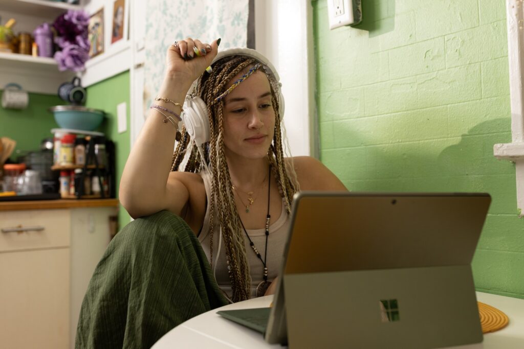 ViaHub a woman with dreadlocks sitting in front of a laptop computer