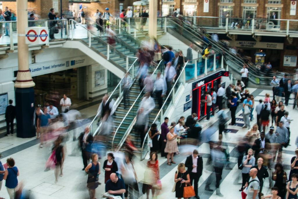 RH Shopping people standing and walking on stairs in mall