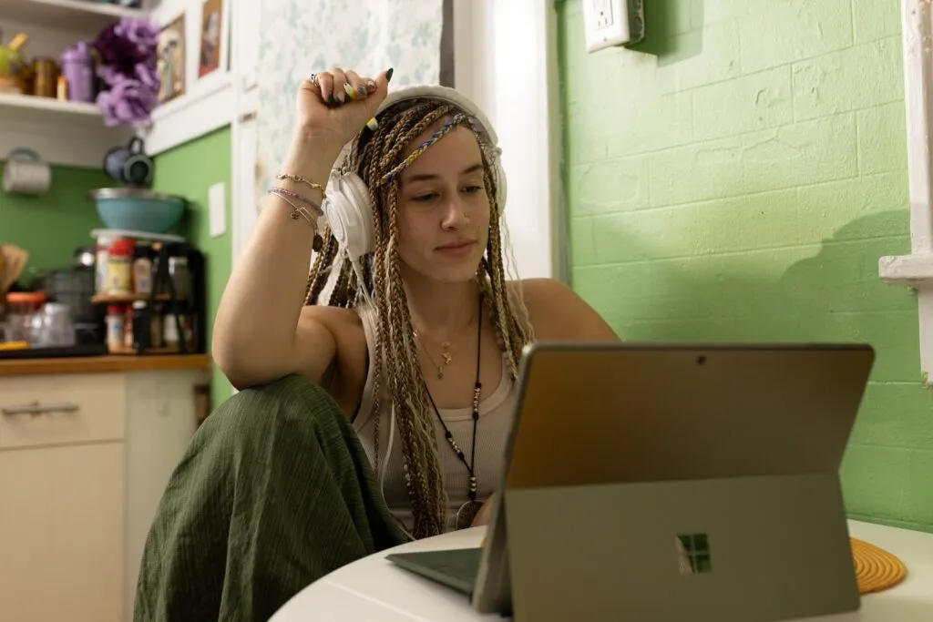 ViaHub a woman with dreadlocks sitting in front of a laptop computer